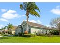 Green house with palm trees, manicured lawn, and attractive landscaping at 101 Marathon Ln, Sanford, FL 32771