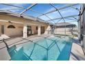 Relaxing screened-in pool area with patio furniture at 1185 N Old Mill Dr, Deltona, FL 32725