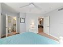 Spacious bedroom with a white bed frame, teal bedding and access to a bathroom and hallway at 3311 S Atlantic Ave # 304, Daytona Beach Shores, FL 32118