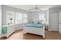 Cozy bedroom with a white bed frame, teal bedding, and ample natural light at 3311 S Atlantic Ave # 304, Daytona Beach Shores, FL 32118