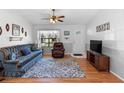 Living room with blue sofa, recliner, and wood floors at 3341 Vancouver Ave, Deltona, FL 32738