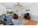 Living room with blue sofa, recliner, and wood floors at 3341 Vancouver Ave, Deltona, FL 32738