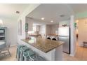 Kitchen with granite countertops, stainless steel appliances, and breakfast bar at 415 Banana Cay Dr # F, South Daytona, FL 32119