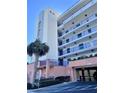 Exterior view of condo building with parking garage at 5300 S Atlantic Ave # 19-502, New Smyrna Beach, FL 32169