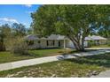 Single-story house with a large tree in front and a sidewalk at 552 Nardello Dr, Deltona, FL 32725