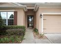 Front entry with glass door, leading to the interior of a charming house at 558 Morgan Wood Dr, Deland, FL 32724