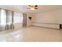 Spacious living room with tile floors and ceiling fan at 1068 North St, Daytona Beach, FL 32114