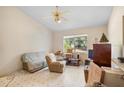 Living room with a sofa, chair, and TV stand, showing a cozy and comfortable space at 1231 Fort Smith Blvd, Deltona, FL 32725