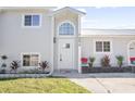 Modern front entrance with a white door and updated landscaping at 1661 Bismarck Dr, Deltona, FL 32725