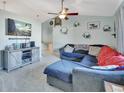 L-shaped sectional sofa, large TV, ceiling fan, and neutral wall colors at 2585 Delbarton Ave, Deltona, FL 32725