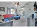 L-shaped sectional sofa, view of entryway, ceiling fan, and neutral wall colors at 2585 Delbarton Ave, Deltona, FL 32725