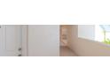 Condo hallway with white walls and light flooring at 2967 S Atlantic Ave # 204, Daytona Beach Shores, FL 32118