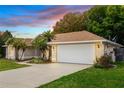 Well-maintained house with a two-car garage and mature landscaping at 54 Spring Ridge Dr, Debary, FL 32713