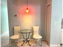 Small breakfast nook with glass table and chairs at 101 N Hill S Ave # 7, Deland, FL 32724
