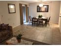 Dining area with wood table and chairs, adjacent to living room at 150 Wax Myrtle Woods Ct # 9D, Deltona, FL 32725