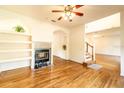 Hardwood floors, fireplace, built-in shelves, and view to staircase at 1907 Enterprise Osteen Rd, Deltona, FL 32738