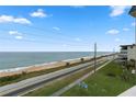 Ocean view from condo balcony, showing beach and road at 2294 Ocean Shore Blvd # 401, Ormond Beach, FL 32176