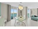 Bright dining room with water views and modern chandelier at 231 Riverside Dr # 701, Holly Hill, FL 32117