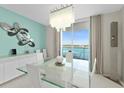 Modern dining area with water views and unique art at 231 Riverside Dr # 701, Holly Hill, FL 32117