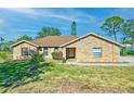 Brick ranch home with landscaped yard and lake view at 2332 Salem Dr, Deltona, FL 32738