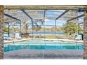 Screened pool and patio overlooking a tranquil lake at 2332 Salem Dr, Deltona, FL 32738
