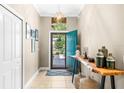 Bright entryway with teal door and a live-edge console table at 242 Westchester Dr, Deland, FL 32724