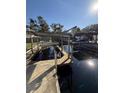 Additional view of private wooden dock and boat lift at 24514 Snail Rd, Astor, FL 32102