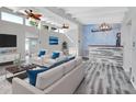 Bright living room featuring hardwood floors, vaulted ceilings, and stylish furniture at 24514 Snail Rd, Astor, FL 32102