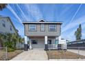 Newly constructed two-story home with gray siding and a white porch at 311 Ora St, Daytona Beach, FL 32118