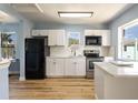 Modern kitchen with white shaker cabinets, quartz countertops, and stainless steel appliances at 311 Ora St, Daytona Beach, FL 32118