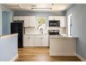 Modern kitchen with white shaker cabinets, quartz countertops, and stainless steel appliances at 311 Ora St, Daytona Beach, FL 32118