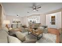 Open living room features hardwood floors, ceiling fan and neutral color palette at 4859 Nw 35Th Lane Rd, Ocala, FL 34482