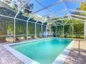 Inviting screened-in pool with brick pavers and lush landscaping at 544 Stone Island Rd, Enterprise, FL 32725