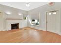 Living room with hardwood floors, fireplace, and large windows at 615 N Palmetto Ct, Deland, FL 32720