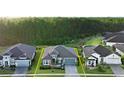 Aerial view of a single-Gathering home with a two-car garage and landscaped yard at 649 Mosaic Blvd, Daytona Beach, FL 32124