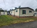 Mobile home with a shed and a spacious backyard at 1632 Bream Dr, Seville, FL 32190