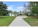 House with carport and nicely landscaped front yard at 2 Walnut Ct, Ormond Beach, FL 32174