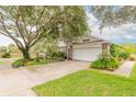 House exterior showcasing a large tree and spacious driveway at 22 Old Macon Dr, Ormond Beach, FL 32174