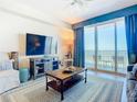 Coastal-themed living room with comfortable seating, large TV, and ocean views at 300 N Atlantic Ave # 1803, Daytona Beach, FL 32118