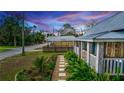 Landscaped pathway leading to a charming blue cottage with a white picket fence at 331 Sheldon St, New Smyrna Beach, FL 32168