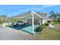 Covered carport area next to the house at 3782 Pine Cone Ln, Ormond Beach, FL 32174