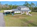 Two-story house with covered parking and landscaped yard at 3782 Pine Cone Ln, Ormond Beach, FL 32174
