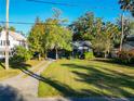 A blue house with a large yard and a long driveway at 410 N Thorpe Ave, Orange City, FL 32763