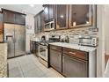 Well-equipped kitchen with stainless steel appliances and granite counters at 704 Ostrich Fern Ln, Deland, FL 32720