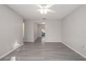 Spacious living room featuring light grey walls and vinyl wood flooring at 711 S Pearl St, Deland, FL 32720