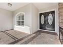 Front entrance with double doors and a side window, showing the stonework at 973 Bearded Oaks Ter, Longwood, FL 32779