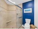 Bathroom with walk-in shower and blue accent wall at 2300 N Atlantic Ave # 1701, Daytona Beach, FL 32118