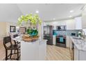 Modern kitchen with white cabinets, granite counters at 2300 N Atlantic Ave # 1701, Daytona Beach, FL 32118