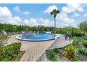 Kidney shaped pool with surrounding patio furniture at 2329 River Ridge Rd # 13, Deland, FL 32720