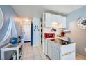 Small galley kitchen with red appliances and nautical theme at 3501 S Atlantic Ave # 2030, Daytona Beach, FL 32118